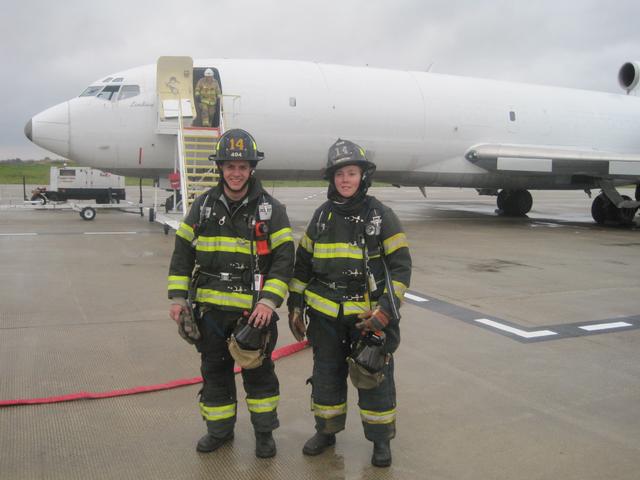 Firefighters Ryan Hay and Jenny Beers at the airport.